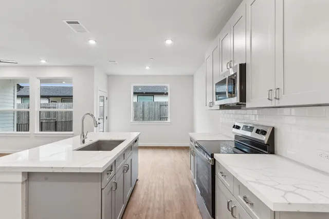 a kitchen that has a sink and a stove
