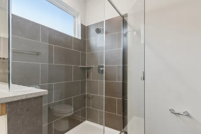 a bathroom with a shower and a sink