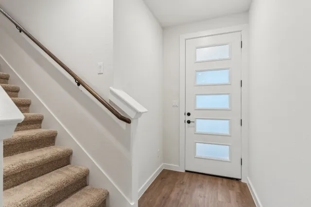 a view of entryway and hall with wooden floor