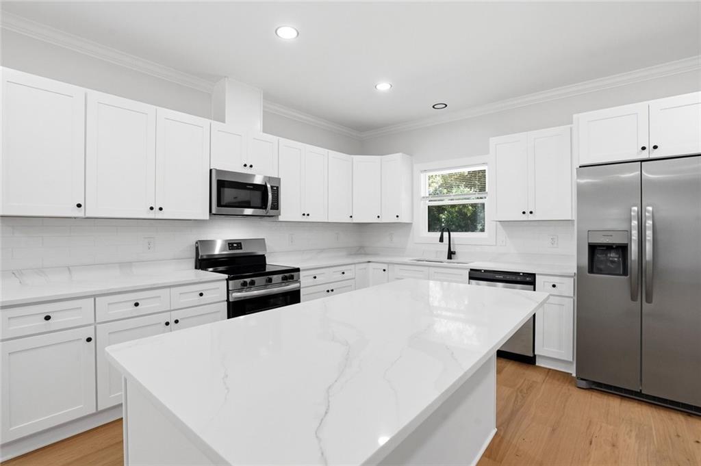 134 Henry Meyer Road Winterville, GA 30683 - Photo 11 of 34 a kitchen with white cabinets and stainless steel appliances