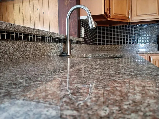 a kitchen with wooden cabinets and a stove top oven