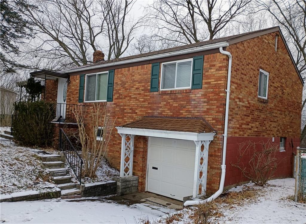 1115 Cascade Drive Homestead, PA 15120 - Photo 20 of 31 a front view of a house with garage