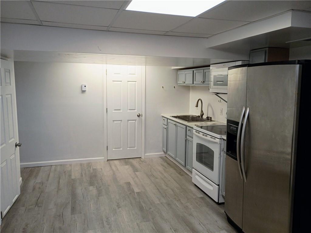 1115 Cascade Drive Homestead, PA 15120 - Photo 21 of 31 a kitchen with stainless steel appliances a refrigerator stove and sink