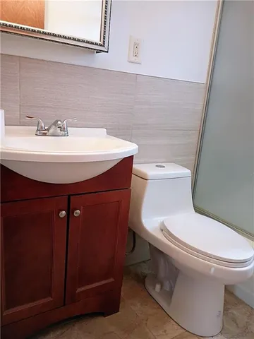 a bathroom with a sink a mirror and a toilet