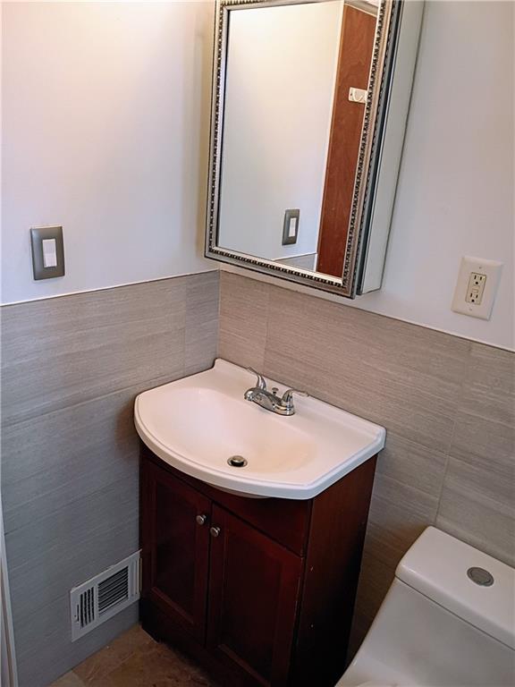 1115 Cascade Drive Homestead, PA 15120 - Photo 28 of 31 a bathroom with a sink a mirror and a toilet