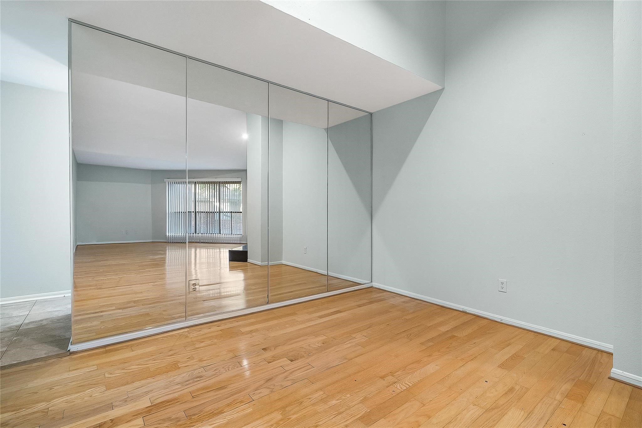 3100 Walnut Bend Lane, Unit 116 Houston, TX 77042 - Photo 5 of 15 a view of empty room with wooden floor and cabinet