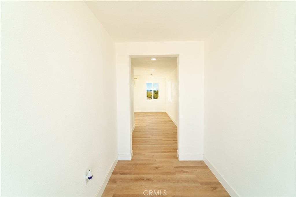 65125 Saturn Street Joshua Tree, CA 92252 - Photo 13 of 40 a view of a hallway with wooden floor
