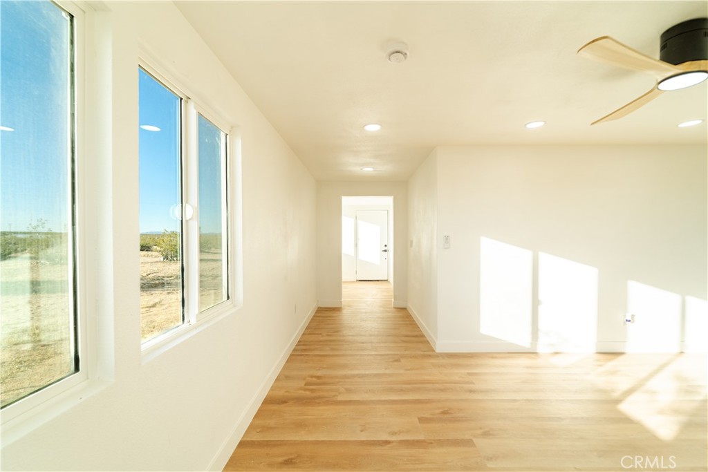 65125 Saturn Street Joshua Tree, CA 92252 - Photo 14 of 40 a view of a hallway with wooden floor and windows