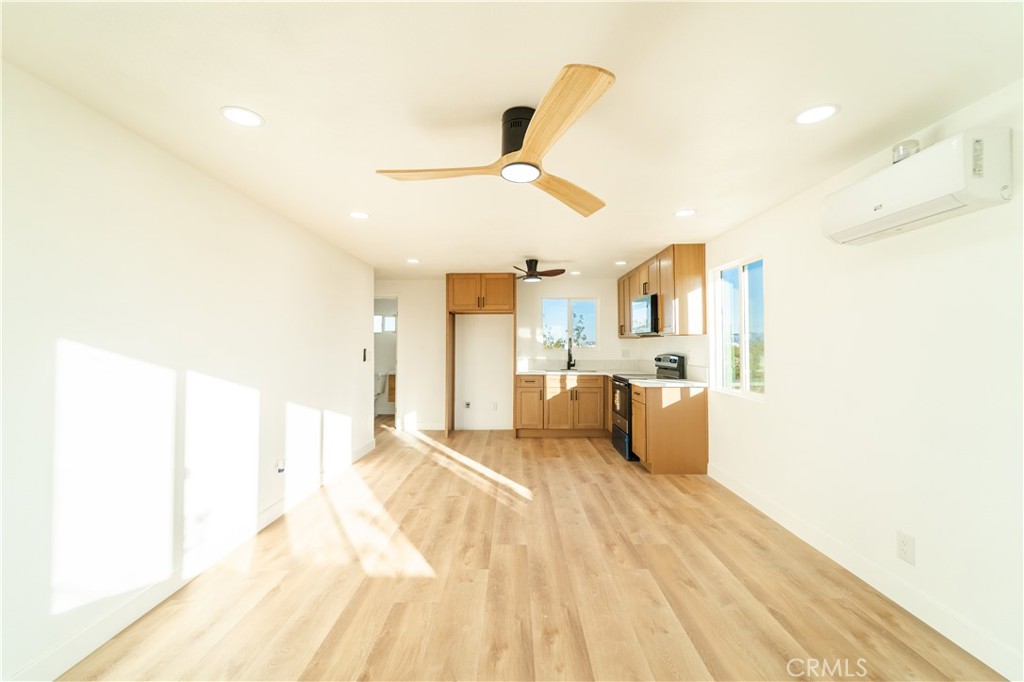 65125 Saturn Street Joshua Tree, CA 92252 - Photo 17 of 40 a bedroom with a bed and ceiling fan