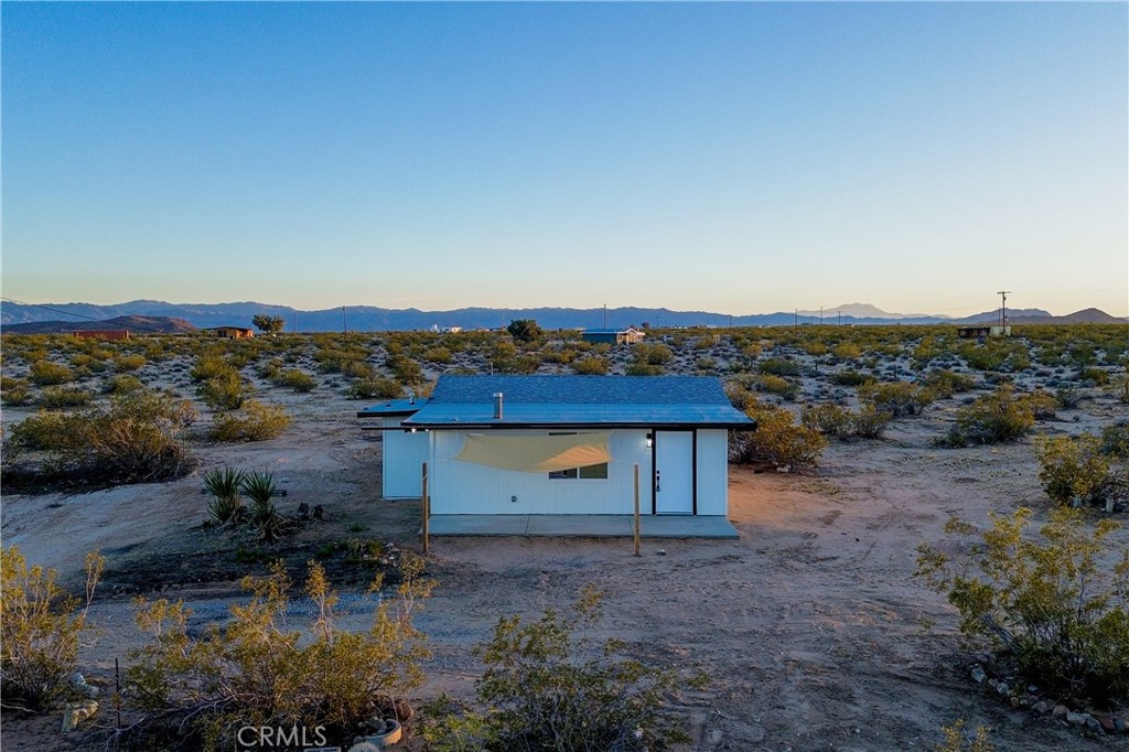 65125 Saturn Street Joshua Tree, CA 92252 - Photo 33 of 40 an aerial view of a house with a yard and lake view
