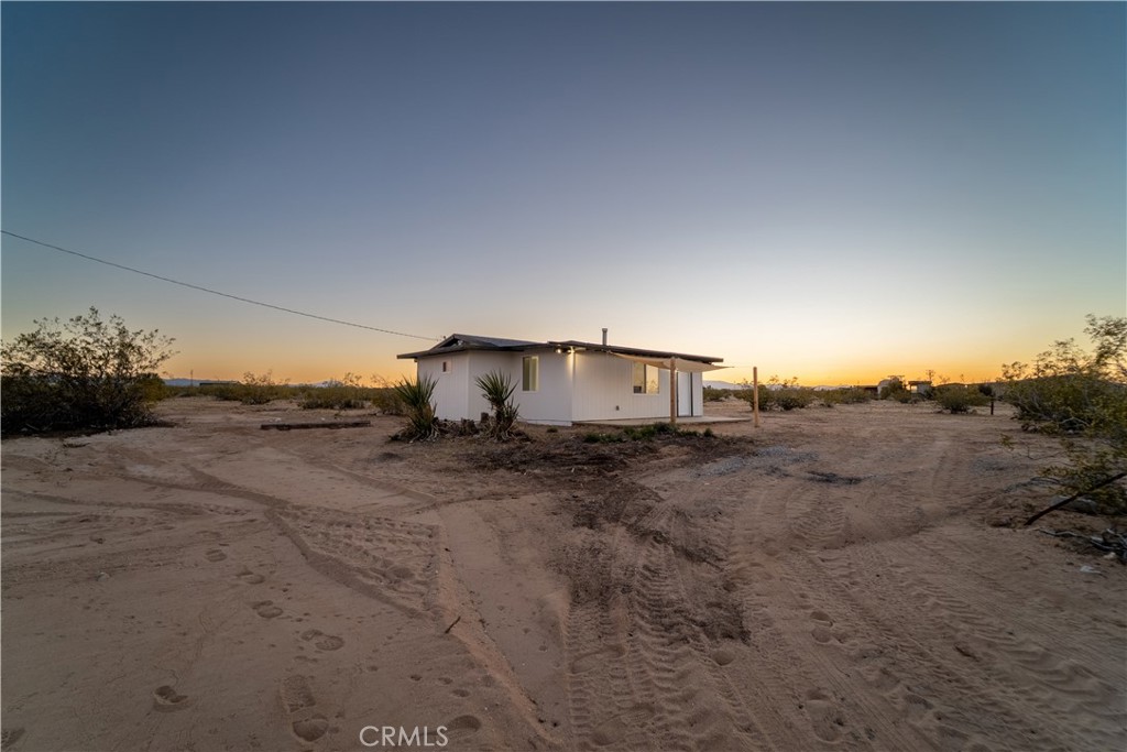 65125 Saturn Street Joshua Tree, CA 92252 - Photo 4 of 40 a view of a dry yard with wooden fence