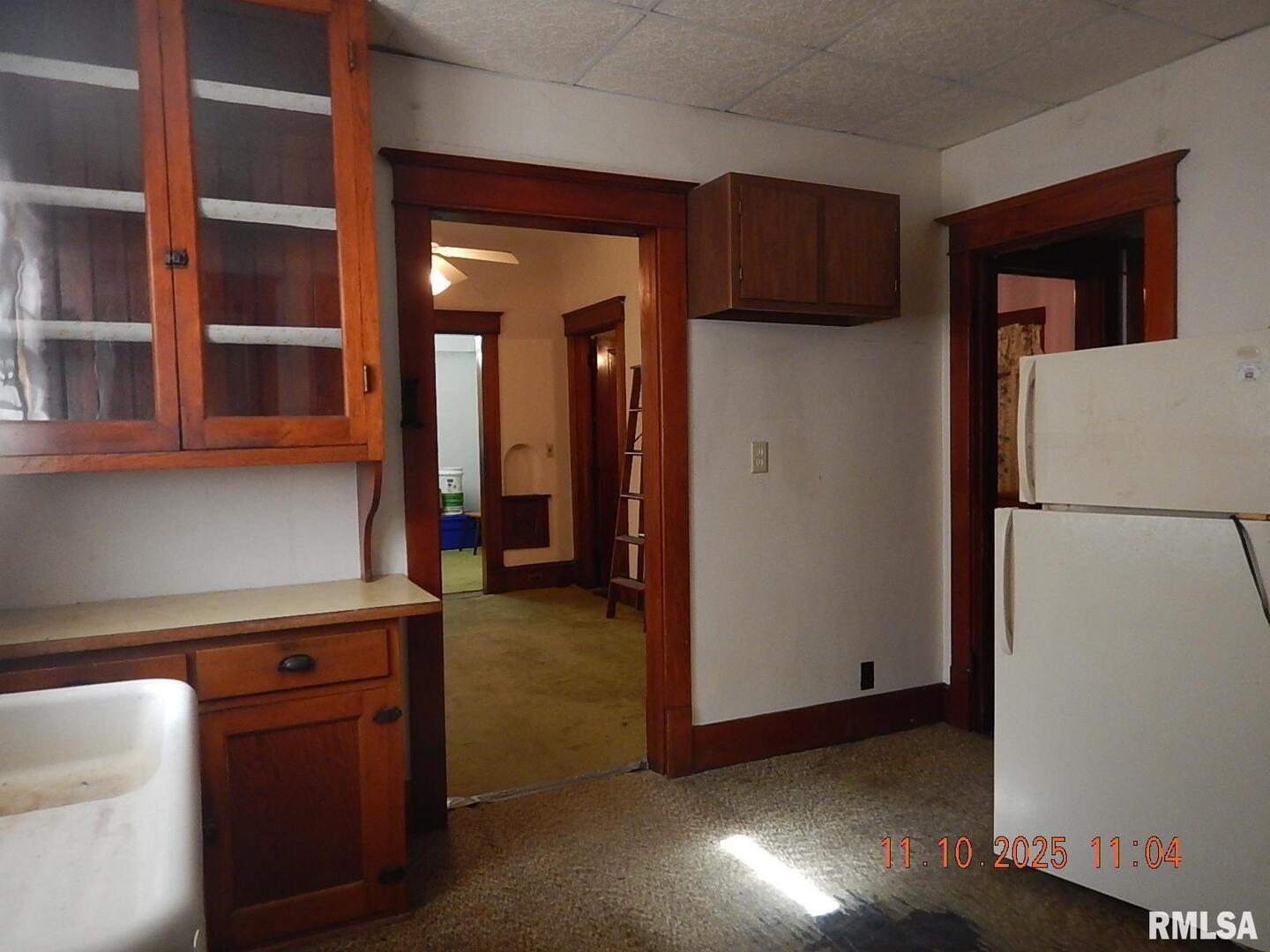 702 Elliott Street, Unit 1 Kewanee, IL 61443 - Photo 6 of 19 a view of a kitchen with a refrigerator and cabinets