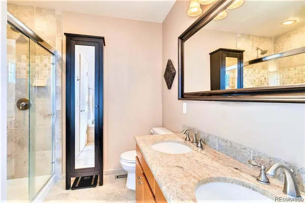 a bathroom with a granite countertop sink and a mirror