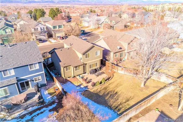 an aerial view of residential houses with wooden fence