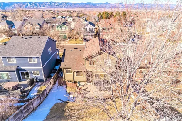 a view of residential houses with wooden fence