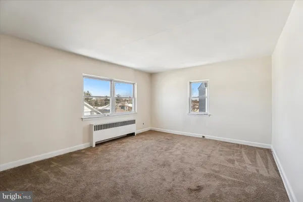 an empty room with a fireplace