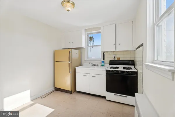 a kitchen with a refrigerator sink stove and cabinets