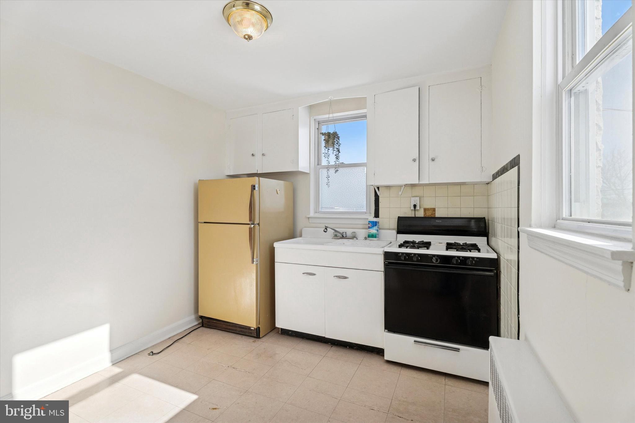 928 Fox Chase Road Jenkintown, PA 19046 - Photo 16 of 31 a kitchen with a refrigerator sink stove and cabinets