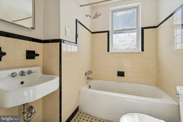 a bathroom with a bathtub and sink