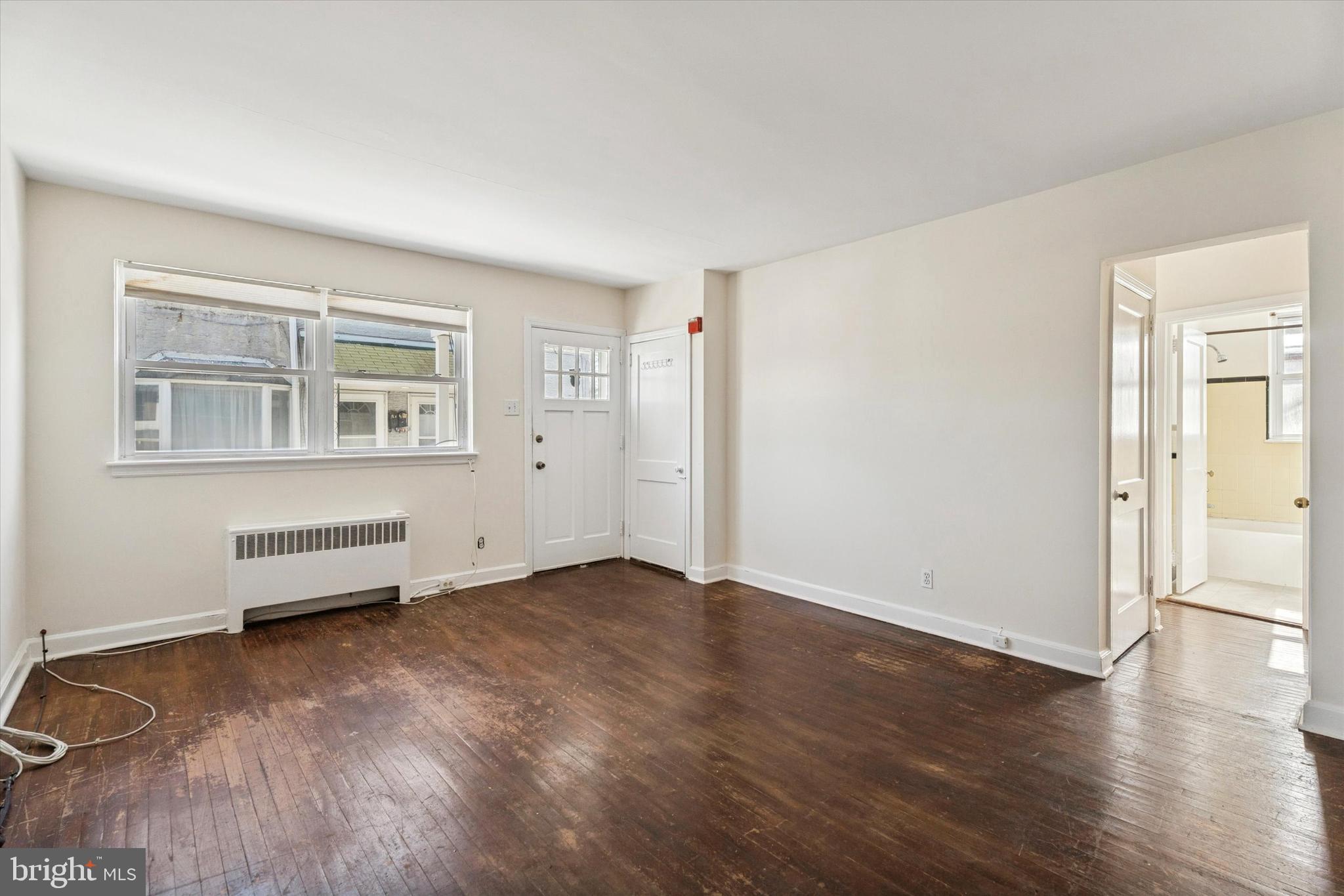 928 Fox Chase Road Jenkintown, PA 19046 - Photo 4 of 31 an empty room with wooden floor and windows