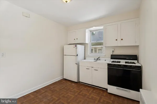 a kitchen with a stove and a refrigerator