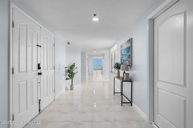 a bathroom with a granite countertop double vanity and a mirror
