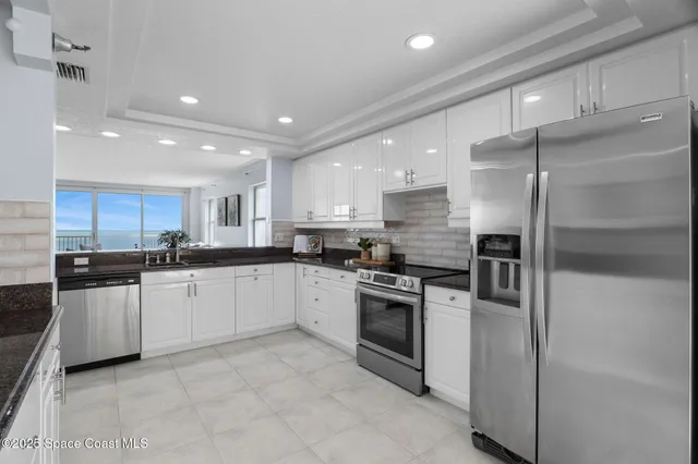 a view of a hallway with wooden floor and stairs