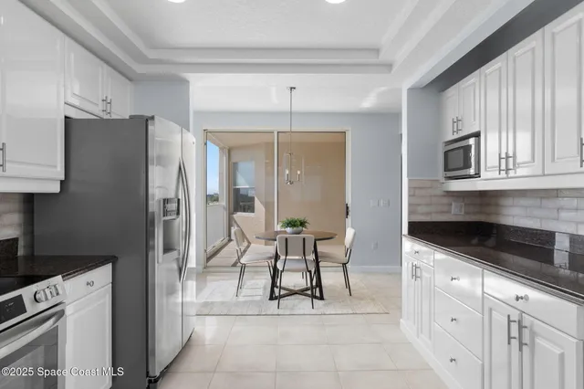 a bedroom with a bed a ceiling fan and a dresser