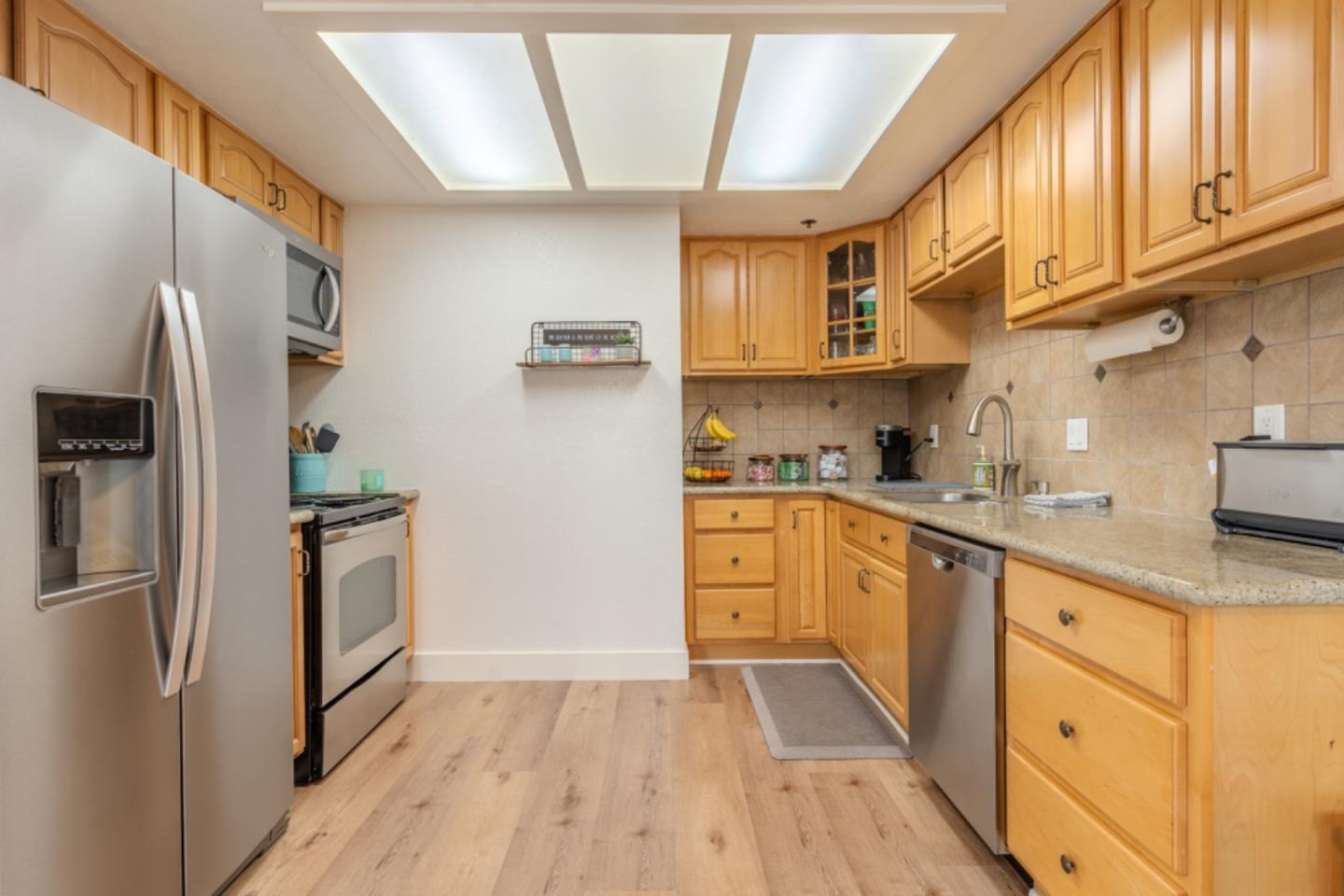 209 Clifton Road Pacifica, CA 94044 - Photo 12 of 31 a kitchen with stainless steel appliances granite countertop a refrigerator sink and cabinets