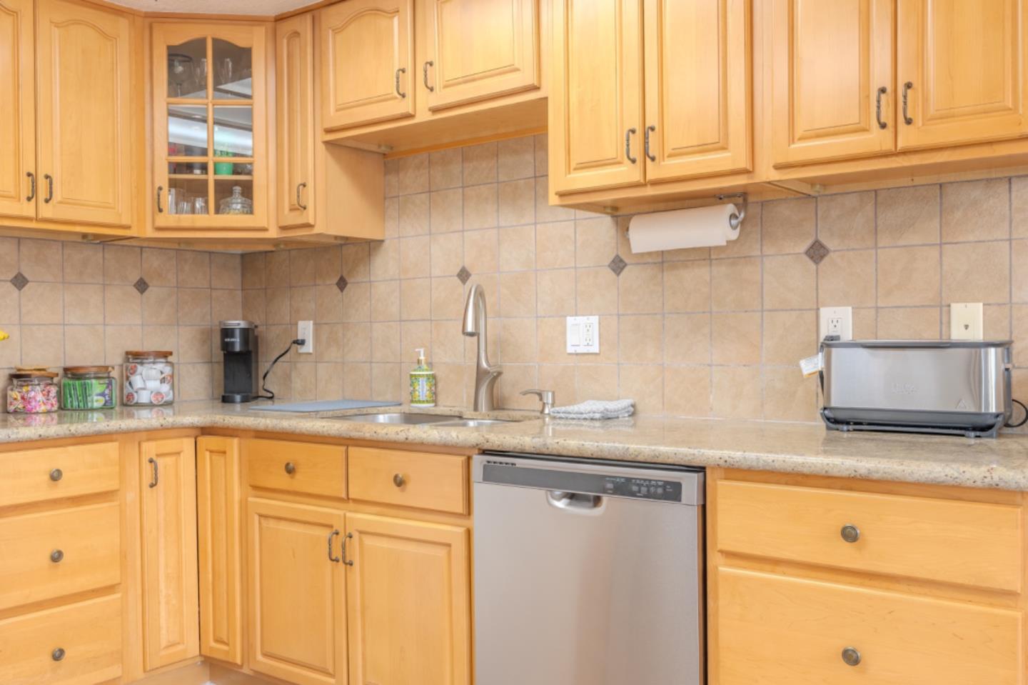 209 Clifton Road Pacifica, CA 94044 - Photo 13 of 31 a kitchen with granite countertop stainless steel appliances white cabinets sink and dishwasher