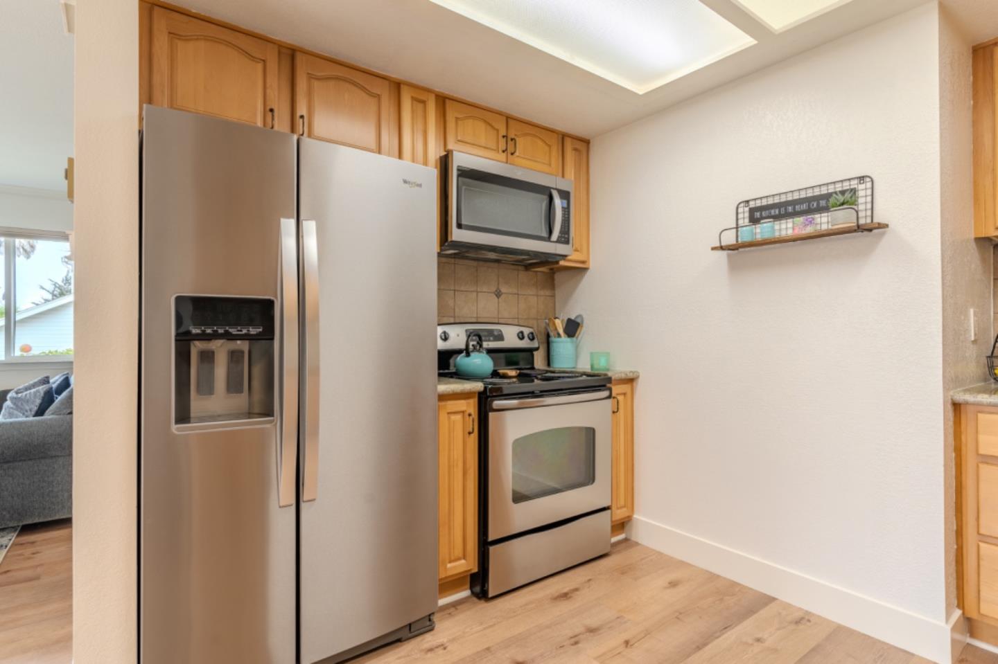 209 Clifton Road Pacifica, CA 94044 - Photo 14 of 31 a kitchen with stainless steel appliances granite countertop a refrigerator and a stove top oven