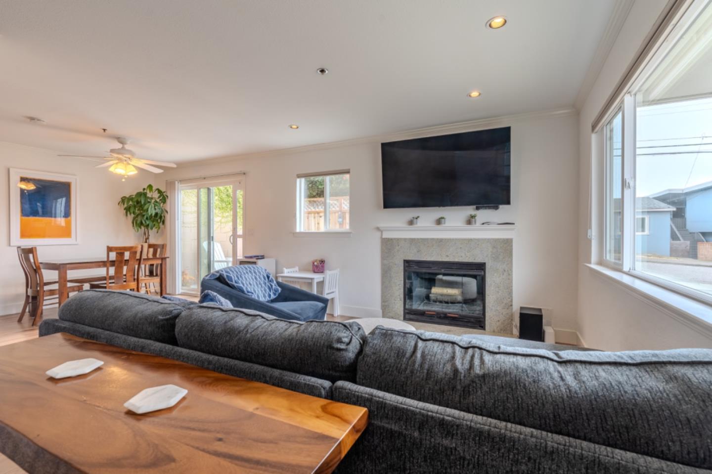 209 Clifton Road Pacifica, CA 94044 - Photo 4 of 31 a living room with furniture flat screen tv and a fireplace