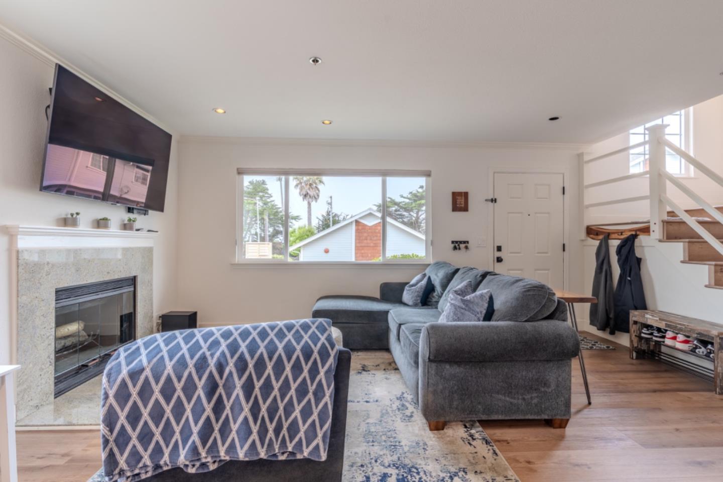 209 Clifton Road Pacifica, CA 94044 - Photo 7 of 31 a living room with furniture and a fireplace