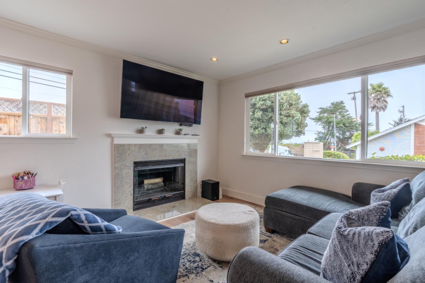 209 Clifton Road Pacifica, CA 94044 - Photo 8 of 31 a living room with furniture a flat screen tv and a fireplace