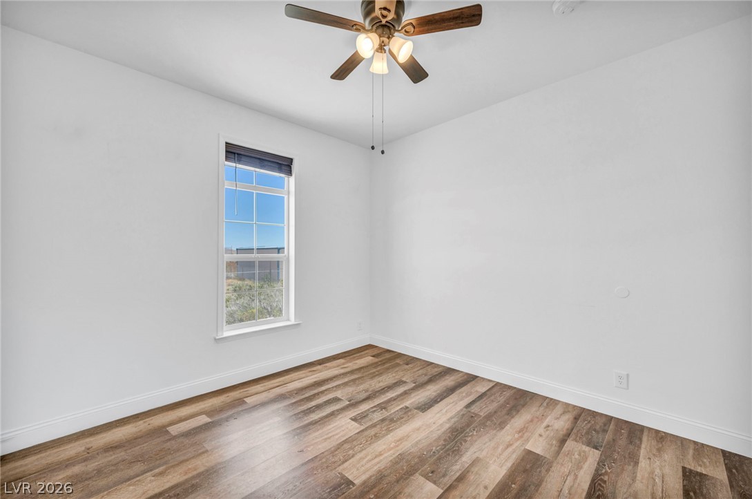 225 California Street Searchlight, NV 89046 - Photo 38 of 64 A well-lit bedroom features sturdy wood flooring and a refreshing ceiling fan.