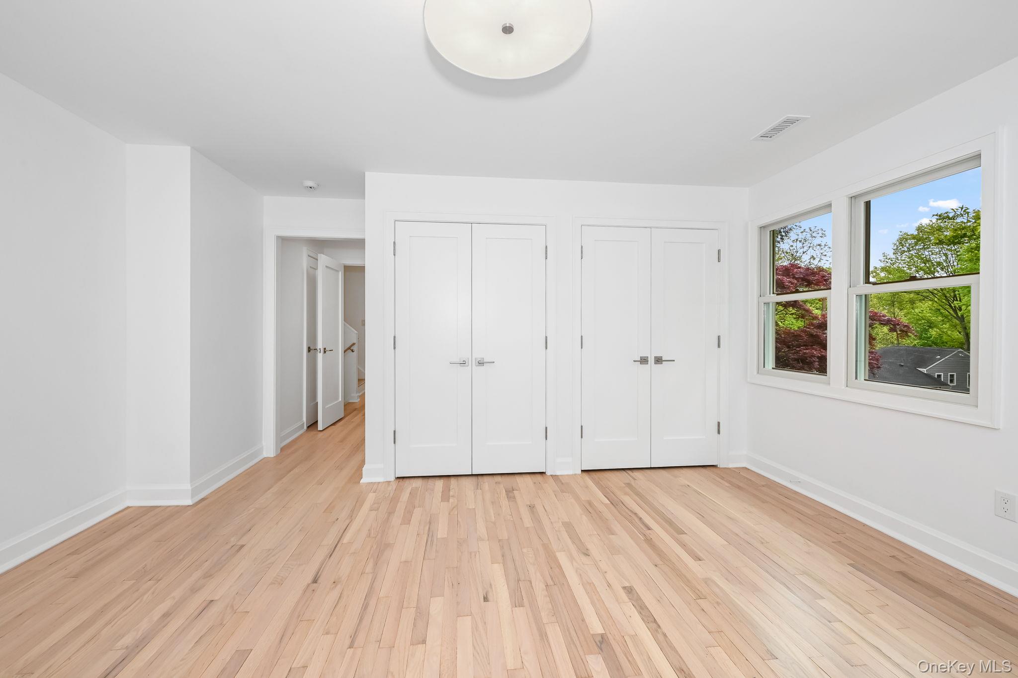 24 Country Road Mamaroneck, NY 10543 - Photo 20 of 37 a view of a room with wooden floor and window