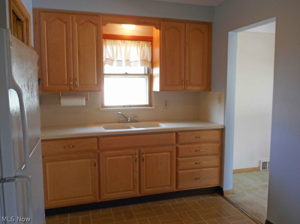 12311 Orme Road Garfield Heights, OH 44125 - Photo 4 of 12 Updated Kitchen with Kraftmaid Brand Cabinets and Corian Brand Countertop.