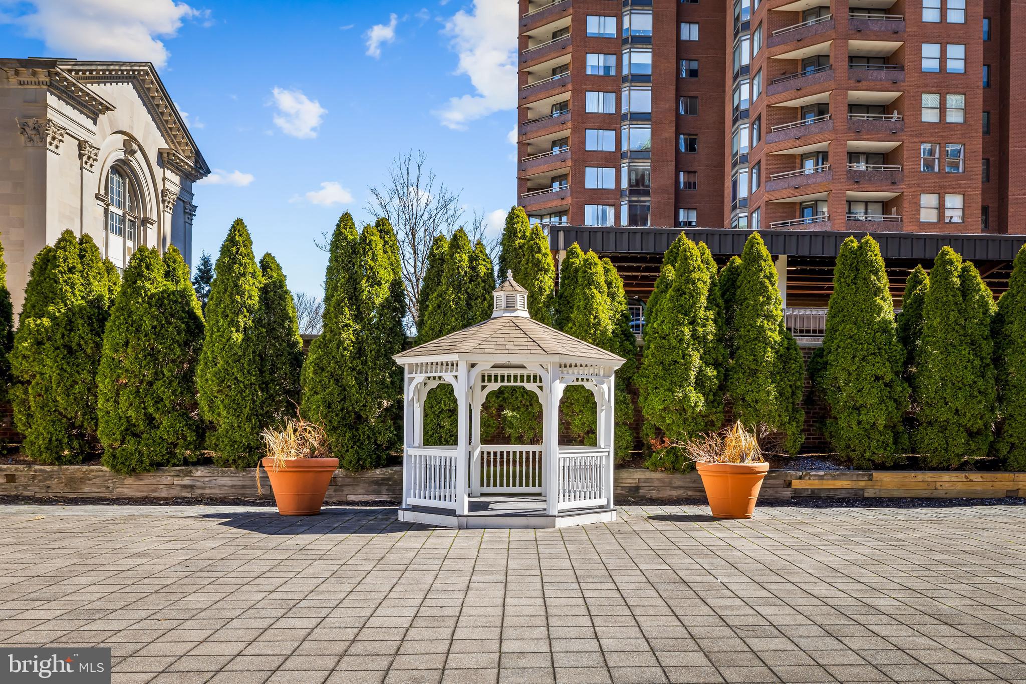 3801 Canterbury Road, Unit 506 Baltimore, MD 21218 - Photo 54 of 60 a view of a building with garden and sitting area
