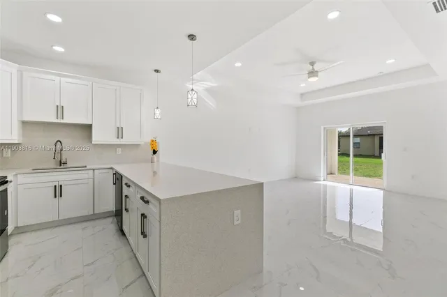 a kitchen with a sink stove and cabinets