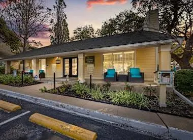 a house view with swimming pool and sitting space