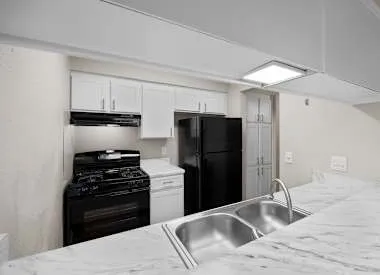 a bathroom with a granite countertop sink a toilet and a mirror