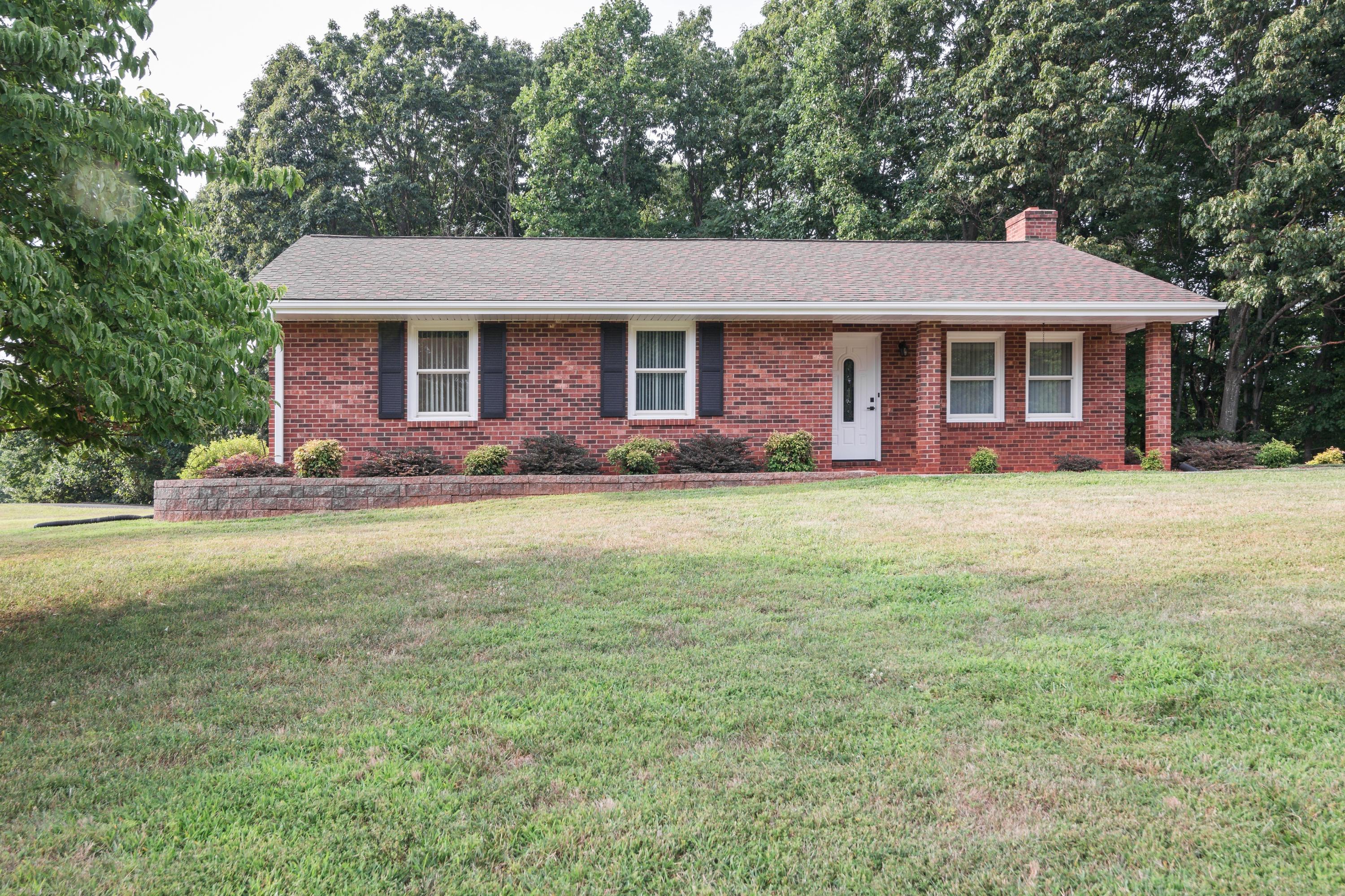 445 Deep Woods Road Hardy, VA 24101 - Photo 1 of 47 a front view of a house with garden