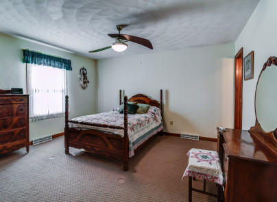 445 Deep Woods Road Hardy, VA 24101 - Photo 15 of 47 a bedroom with a bed chair and dresser