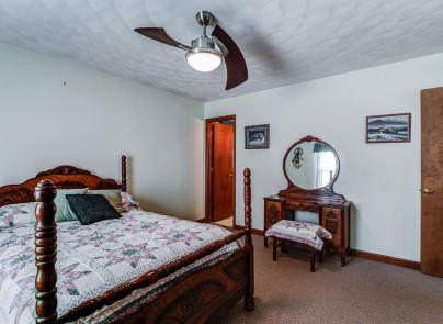 445 Deep Woods Road Hardy, VA 24101 - Photo 16 of 47 a bedroom with a bed and a chandelier
