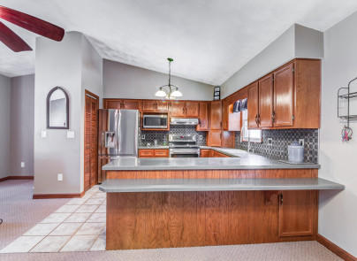 445 Deep Woods Road Hardy, VA 24101 - Photo 9 of 47 a kitchen with kitchen island granite countertop wooden cabinets and white appliances