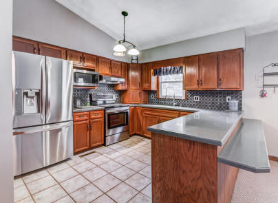 445 Deep Woods Road Hardy, VA 24101 - Photo 10 of 47 a kitchen with stainless steel appliances granite countertop a refrigerator a sink dishwasher a stove with wooden cabinets