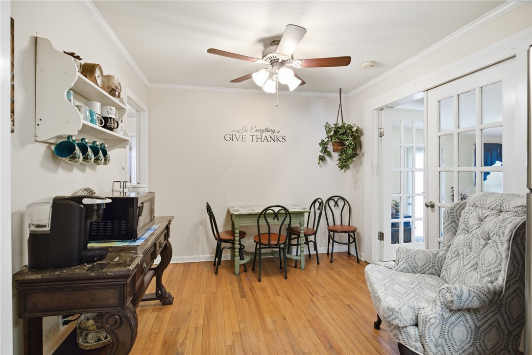 108 Hodge Street Abbeville, SC 29620 - Photo 4 of 39 Hardwood floors and French doors distinguish this versatile breakfast nook with a decorative ceiling fan.