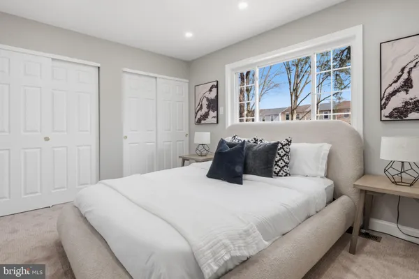 a bedroom with a large bed and a window
