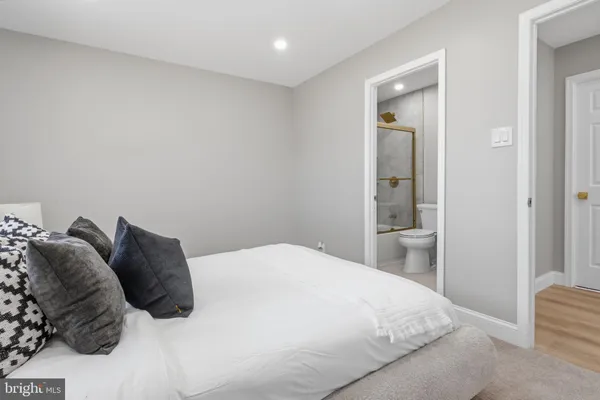 a bedroom with a bed and a mirror