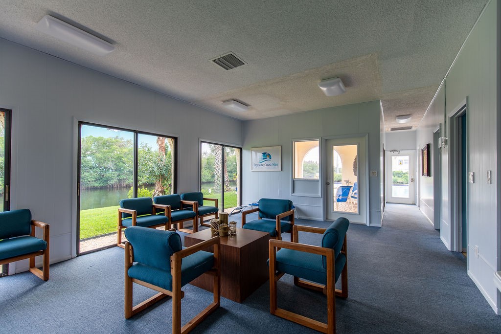 1815 Robalo Drive, Unit C201 Vero Beach, FL 32960 - Photo 28 of 31 a living room with furniture and a floor to ceiling window